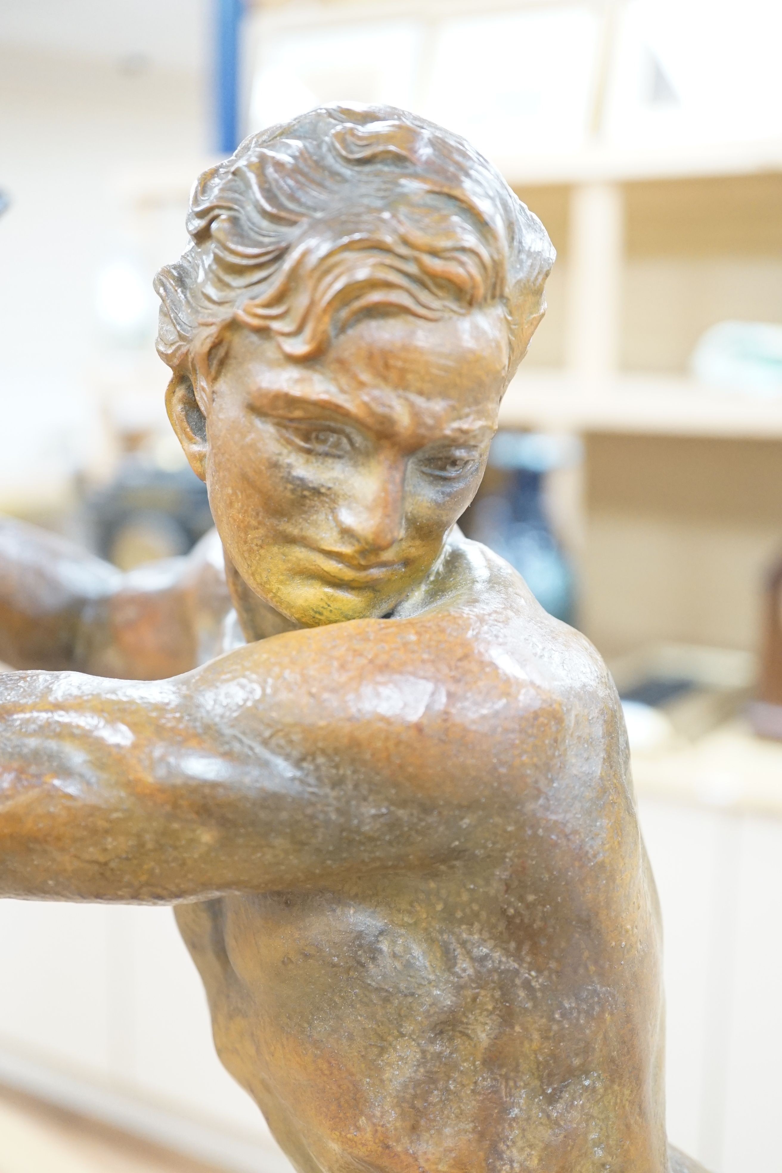 An Art Deco bronzed metal woodcutter, signed G Hervore, 75cm long